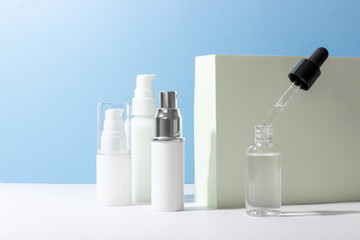 Set of white cosmetic bottles and jars with hard shadows. Beauty salon concept.