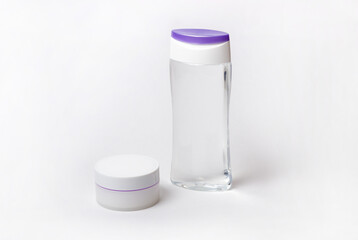 Tube with cream and face tonic on a white background. White bottles with cosmetic products. Professional skin care and wellness concept