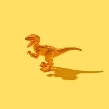 Screaming dinosaur toy with shadows.