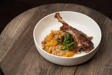 Roasted turkey and couscous on wooden table background