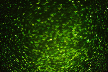 On black isolated background texture of green defocused hearts bokeh. Greeting card. Banner for website, poster. Template preparation for Valentine's, Mother's, St. Patrick's Day, March 8. Copy space