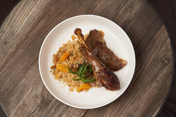 Roasted turkey and couscous on wooden table background