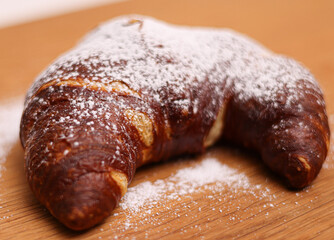 Delicious French croissant with sugar - close up shot