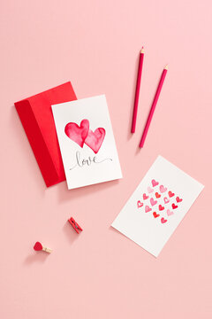 Watercolour heart on a pink background, envelope with a greeting card. Valentine day concept