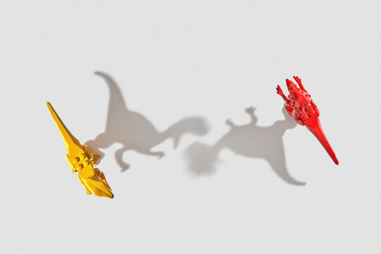 Two shadows from dinosaurs toys.