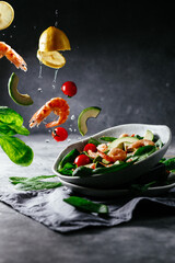 Levitating salad with prawns, avocado and spinach.