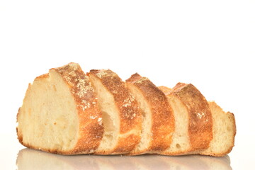 Fragrant French hearth bread sliced into slices, close-up, isolated on white.