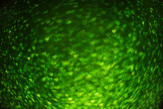 On black isolated background texture of green defocused hearts bokeh. Greeting card. Banner for website, poster. Template preparation for Valentine's, Mother's, St. Patrick's Day, March 8. Copy space
