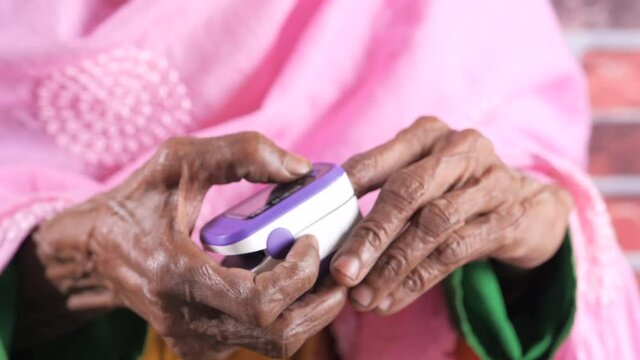 senior women hand using pulse oximeter
