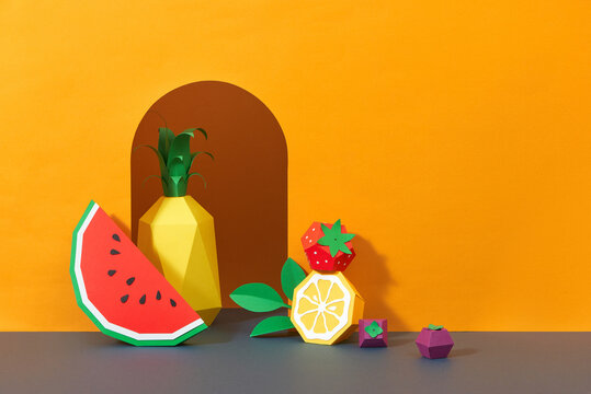 Fruit made of paper. Yellow background.
