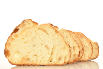 Fragrant French hearth bread sliced into slices, close-up, isolated on white.