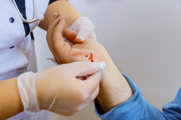 Medical services wipes bandages doctor on the injured hand