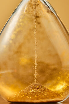 Macro view of falling golden sand.