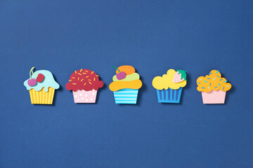 Set cupcake paper cut on blue background