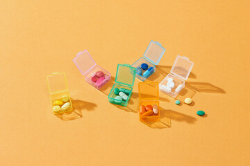 Pill box with a drug on yellow