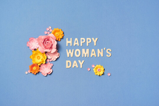 Creative layout made with pink and yellow flowers on bright background. Flat lay. Woman's day minimal concept.