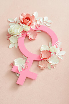 Gender symbol frame with colorful paper flowers. Flat lay