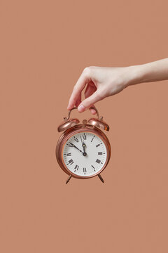 Retro cooper alarmclock in hand.