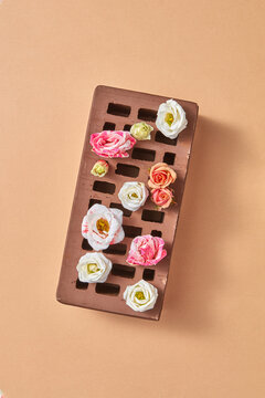 Roses flowers on a perforated brick.