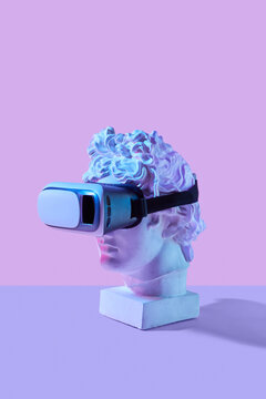 Plaster statue head wearing in virtual reality 3d glasses.