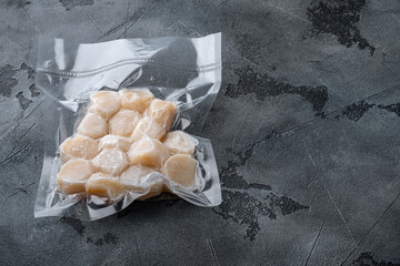Scallops in vacuum pack, on grey background  with copy space