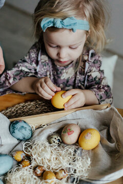 Funny little girl with colorful eggs on Easter