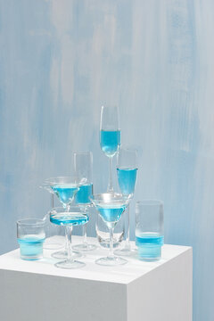 Rows of wine glasses with blue cocktail on table