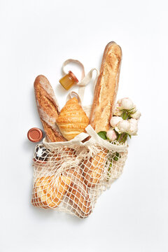 Net bag with bakery and roses flowers.