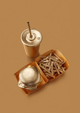 Cheeseburger, fries and cola painted golden.