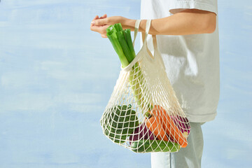 Male hands hold eco bag of vegetables