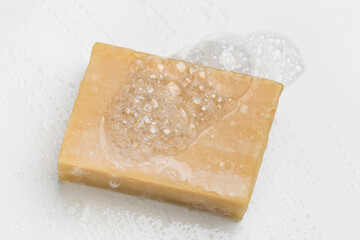 Soap bar and foam on white background, top view. Mockup for design