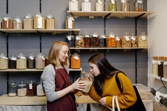 Seller offering buyer product for trial in organic shop