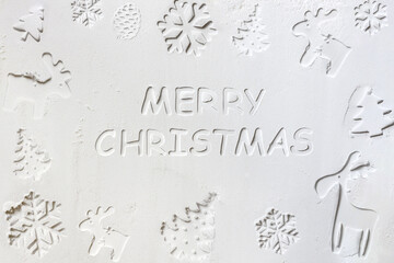 2021 new year background. Baked letters Merry Christmas, stars, snowflakes on a white flour background. Merry Christmas and Happy New Year concept