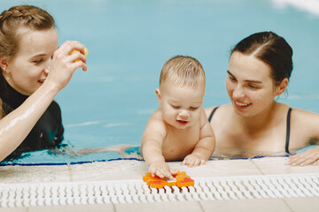 Little cute baby boy. Instructor with kid. Mother with son.