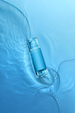 Moisturizing serum for dry skin stands in the water