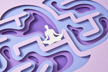 Paper handmade configuration of human brain with meditating man.