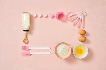 Frame of food ingredients for baking on a gently pink pastel background. Cooking flat lay with copy space. Top view. Baking concept. Mockup.