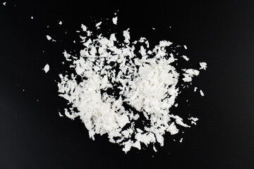 white artificial synthetic snow on black background