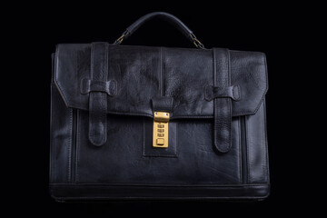 Studio lighting. dark background. Black briefcase in retro style. Close-up.