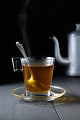 Green tea in glass cup and black background