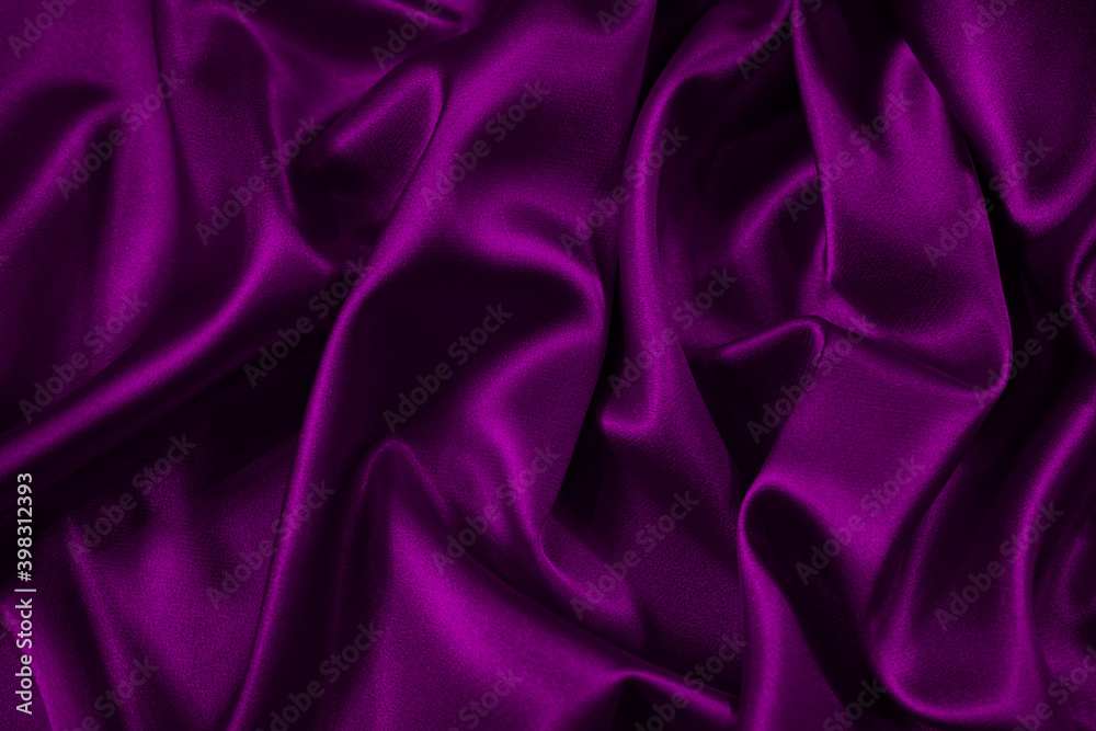 Wall mural purple silk satin fabric. elegant abstract background in magenta colors. liquid wave or silk wavy fo