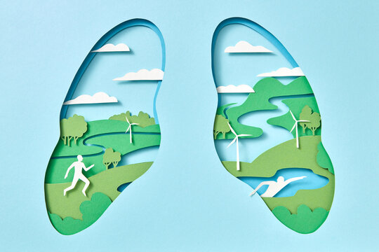 Model of lungs with natural ecosystem and man riding a bike handmade from paper.