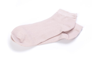 Pair of pink short socks on white background, top view