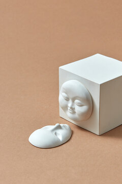 Plaster cube and two face masks.