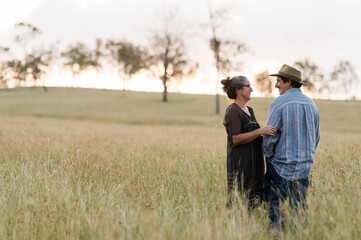 A middle aged couple in a field