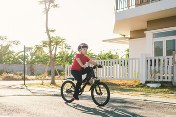 Urban biking - Young boy riding bike in city park