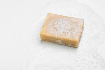 Soap bar and foam on white background, top view. Mockup for design