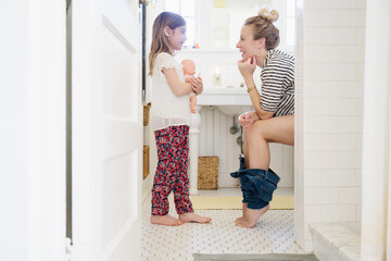 Daughter Talking to Mother on Toilet