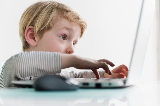 Preschool-Aged Boy Typing on Laptop