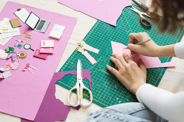 Woman's hand cut paper. Artist doing paper craft.